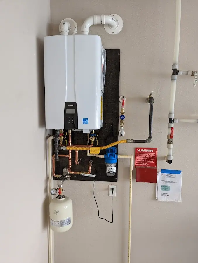 Professional plumber installing copper piping in a Platte City home